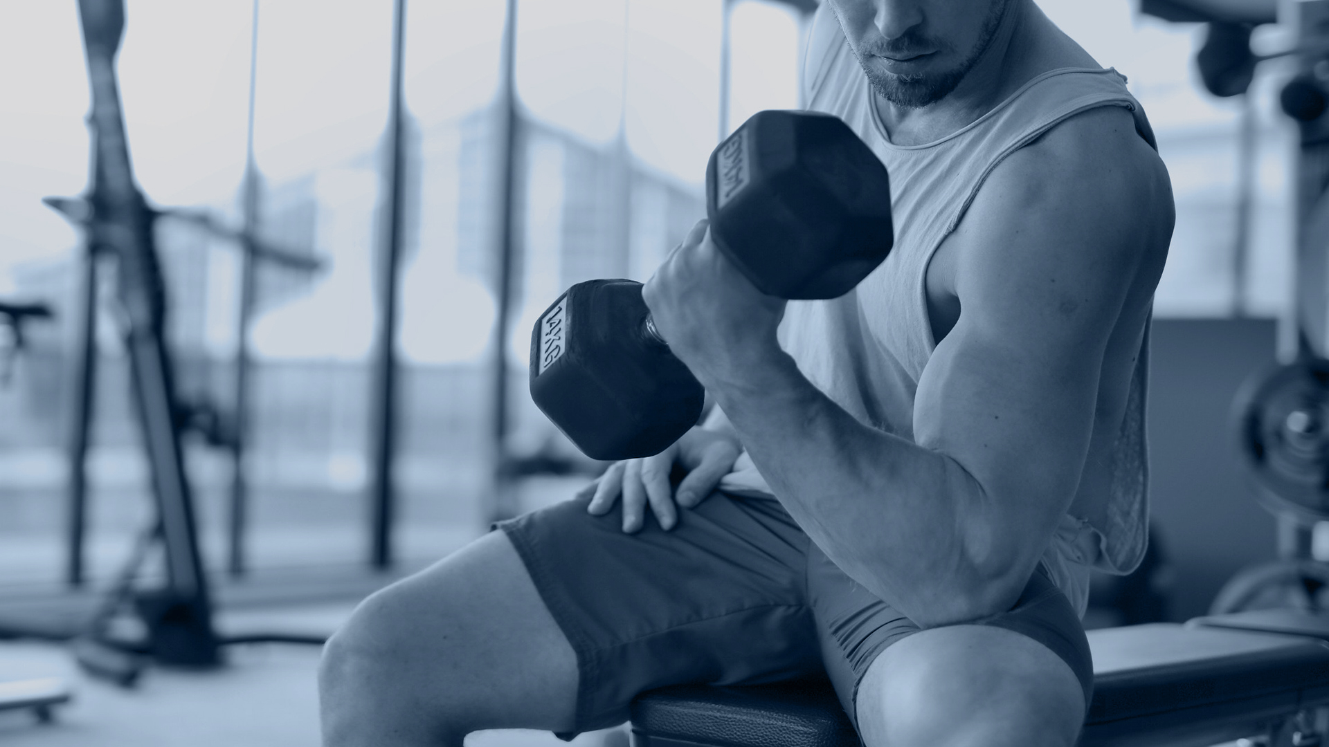 Man lifting dumbbells in gym at Radisson Blu Hotel & Spa Sligo
